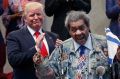 Republican presidential candidate Donald Trump applauds as he is introduced by boxing promoter Don King.