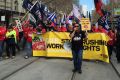 Thousands of people walk down Bourke Street to Parliament House, protesting about the sacking of 55 workers from CUB.