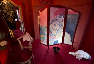 A copy of a painting by Andre Derain titled Woman in a Chemise of a Dancer (1906) is painted on a folding screen in a brothel setting in the Red Light District, part of an installation of three mock prostitute's rooms set up to promote the Easy Virtue exhibition at the Van Gogh Museum in Amsterdam, Netherlands, Tuesday, March 15, 2016.