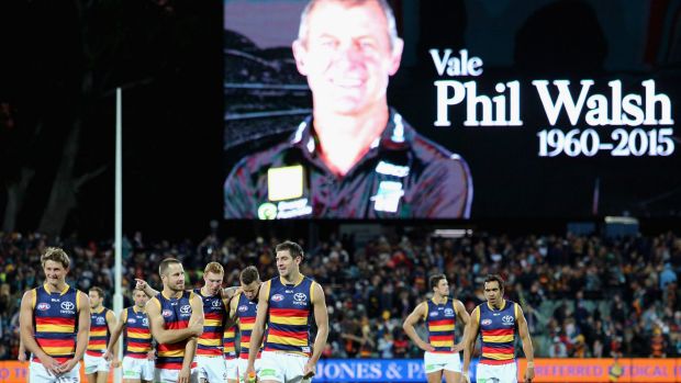 Flood of emotion: Adelaide players walk from the field after round 16, as a tribute is paid to coach Phil Walsh.