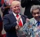 Republican presidential candidate Donald Trump applauds as he is introduced by boxing promoter Don King.