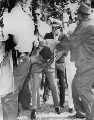 Dr Martin Luther King jnr holds his head after being struck by a rock as he was leading about 600 demonstrators on a ...