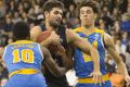 Melbourne United's Todd Blanchfield fights for the ball with UCLA's Isaac Hamilton and Lonzo Ball on Saturday night.