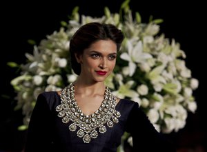 In this Sunday, Aug 4, 2013, photo Bollywood actor Deepika Padukone displays a creation by Indian designer Manish Malhotra during the Delhi Couture Week  in New Delhi, India. (AP Photo/Tsering Topgyal)