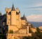 Alcazar castle and snow-capped mountains.