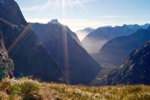 A man looks down towards Milford Sound from Gertrude Saddle in Fjordland National Park on the South Island New Zealand.