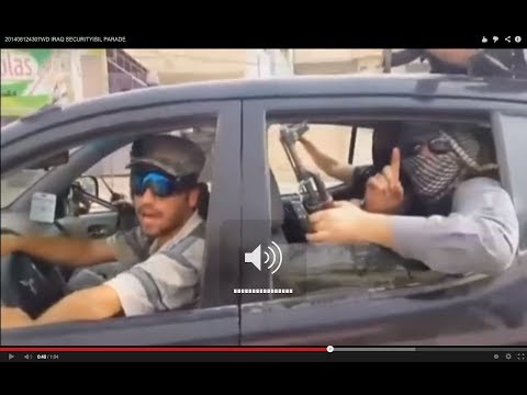 Fighters from Islamic State of Iraq and the Levant parade through Mosul with black flags.