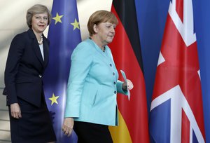 German Chancellor Angela Merkel, right, and British Prime Minister Theresa May, left, arrive for a joint news conference as part of a meeting at the chancellery in Berlin Wednesday, July 20, 2016, on May's first foreign trip after being named British Prime Minister. (AP Photo/Michael Sohn)