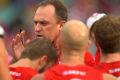 Swans coach John Longmire speaks to the players at half time during the round 20 match against Port Adelaide Power.