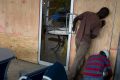 Workers set up a board as protection against hurricane Matthew in an hotel in Kingston, Jamaica.