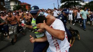 Terrible scenes: A police officer shields a man during the infamous Cronulla riots of 2005.