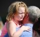 Lilly Chapman, 8, cries after being reunited with her father, John Chapman at Oakdale Baptist Church on in Townville, ...