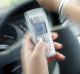 Pic shows a set up shot of a person in the driver seat of a car with their mobile phone in hand - to illustrate the ...