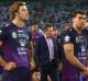 Dejected: Storm coach Craig Bellamy and several players after the game.