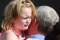 Lilly Chapman, 8, cries after being reunited with her father, John Chapman at Oakdale Baptist Church on in Townville, ...
