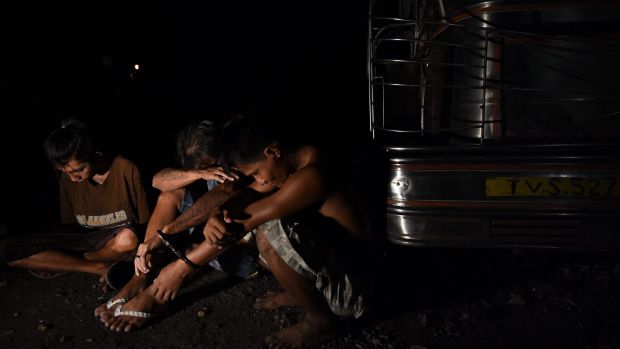 Three men arrested at the scene where three men were killed in a drug related killing in Caloocan, Manila, Philippines.