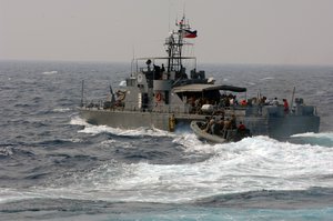 An 11-meter rigid hull inflatable boat operated by members of the U.S. Joint Special Operations Task Force-Philippines (JSOTF-P) pulls alongside a Philippine Navy patrol boat.