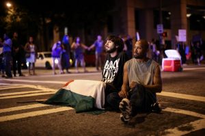 Black Lives Matter protesters sit in the middle of Peachtree Street during a protest in downtown Atlanta, US.