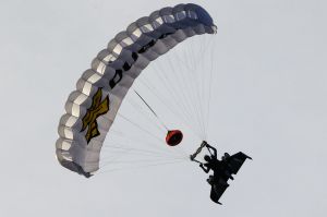 Swiss pilot Yves Rossy, known as 'Jetman,' the first man in the world to fly a jet-fitted wing, prepares to land with ...