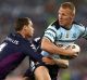 Luke Lewis of the Sharks is tackled during the 2016 NRL Grand Final match.