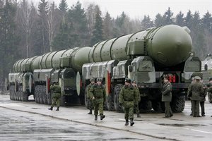 Russian troops are seen near truck-mounted Topol-M intercontinental ballistic missiles as they rehearse for the Victory Day parade in Moscow's Red Square, at a training field in the town of Alabino outside Moscow, Tuesday, March 18, 2008. Nuclear missiles and tanks will once again roll across Red Square during Russia's May 9 Victory Day parade, a top general said Wednesday _ a revival of a Cold War tradition that once evoked feelings of pride in the U.S.S.R. and unease in the W