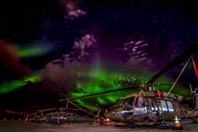 The Aurora Borealis shimmering above UH-60 Black Hawk helicopters. The Northern Lights are just one facet of what makes service in magnificent
Alaska so unique.
