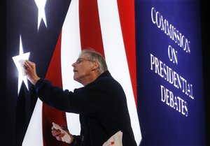 Michael Foley polishes one of the lighted stars on the set for the vice-presidential debate between Republican vice-presidential nominee Gov. Mike Pence and Democratic vice-presidential nominee Sen. Tim Kaine at Longwood University in Farmville, Va., Monday, Oct. 3, 2016.