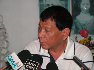 Davao City Mayor Rodrigo Duterte answers questions from reporters during a press conference at the Roman Catholic Cemetery in Davao City, Philippines.