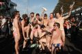 Nine Australian men celebrate in Budgy Smuggler-brand swimsuits decorated with the Malaysian flag at the conclusion of ...