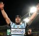 Prime real estate: Michael Ennis celebrates winning the grand final but the Sharks' front-of-jersey sponsorship may be ...