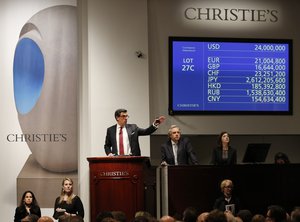 Auctioneer Andreas Rumbler takes bids on Monet's "Water Lilys," during Christie's Impressionist and Modern Art spring sale Thursday, May 12, 2016, in New York.