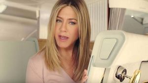 Jennifer Aniston finds a little surprise in her first class seat.