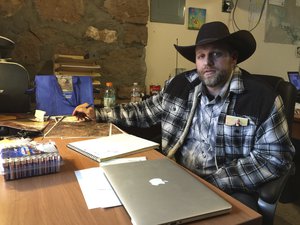 In this Jan. 22, 2016, file photo, Ammon Bundy sits at a desk he is using at the Malheur National Wildlife Refuge in Oregon.