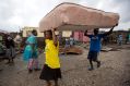 Residents carry a mattress to a shelter after homes were destroyed by Hurricane Matthew in Les Cayes, Haiti.