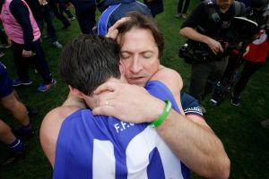 Skipper Easton Wood shares a moment with Luke Beveridge.