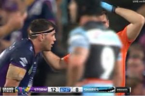 Not removed from field: Dale Finucane is attended to by a Storm trainer during the 2016 grand final against Cronulla ...