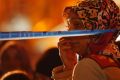 A woman watches behind a police line at the scene of a blast in Istanbul on Thursday.