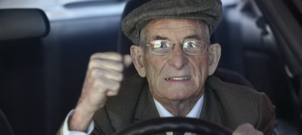 Close-up of a senior man driving a car