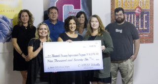 Aimee Atteberry and Anna Harrison, C-VILLE Weekly's publisher and marketing director, present a $9,076 check to the 2016 Best Of C-VILLE party's benefactor, the Albemarle Housing Improvement Program. Pictured from left to right, back to front: Ravi Respeto with AHIP, Dave Frye with sponsor Lockn' Festival, Carrie Slaughter with sponsor Ting, Thomas Roper with sponsor Ting, Aimee Atteberry with C-VILLE, Jennifer Jacobs with AHIP and Anna Harrison with C-VILLE. Staff photo