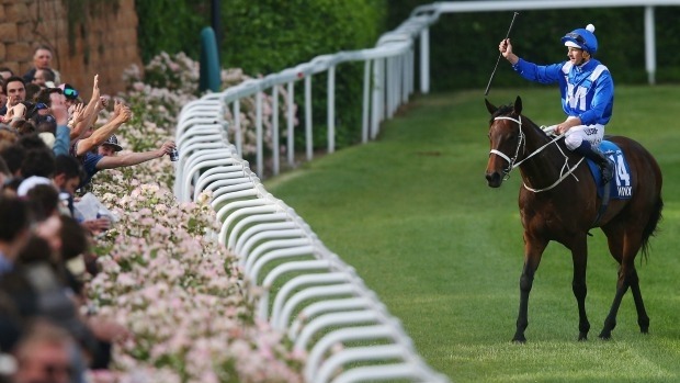 Hugh Bowman riding Winx celebrates with the crowd after winning last year's Cox Plate.