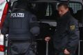 Police officers surround an apartment in the eastern city of Chemnitz, where German police are searching for a man ...