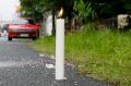 A candle marks the spot where three bodies were dumped by unknown men along a secluded street in suburban Quezon City ...