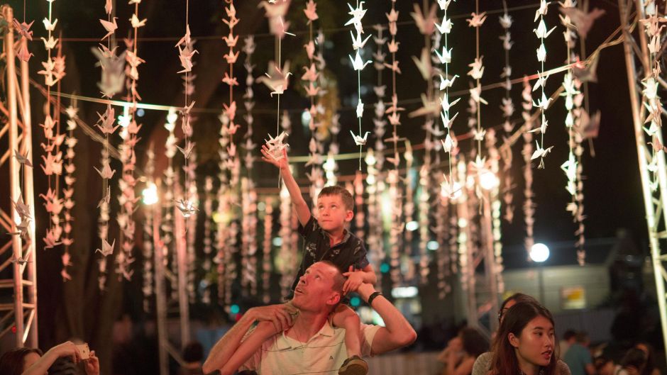 Geoff Croxson son, Ethan is captivated by the paper crane installation at the Night Noodle Markets in Hyde Park.