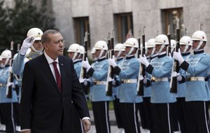 Turkey's President Recep Tayyip Erdogan inspects a military honour guard as he arrives to address the parliament in Ankara, Turkey, Saturday, Oct. 1, 2016.