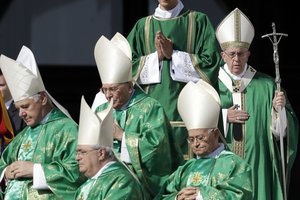 Pope Francis, right, arrives to celebrate a jubilee mass, in St. Peter's Square, at the Vatican