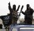 Members of al Qaeda's Nusra Front gesture as they drive in a convoy touring villages in the southern countryside of Idlib