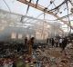 People inspect the aftermath of the strike on the Sanaa reception hall, which killed at least 100 people and injured ...