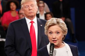 Democratic presidential nominee Hillary Clinton speaks as Republican presidential nominee Donald Trump looks on during ...