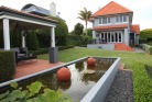 The colours and form of the pond are in harmony with the house.