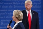 Democratic U.S. presidential nominee Hillary Clinton speak as Republican U.S. presidential nominee Donald Trump looks on ...